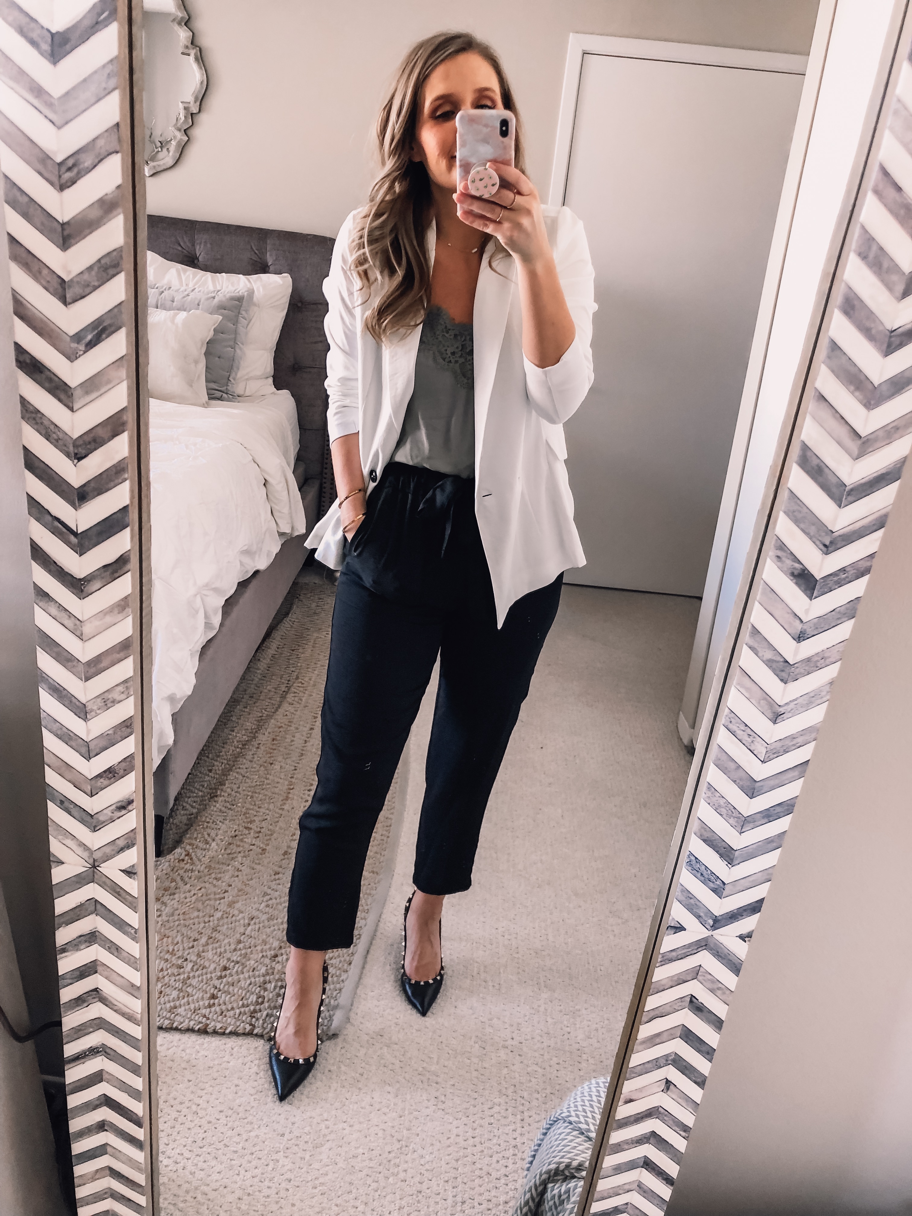 white blazer, black work pants, and green lace top