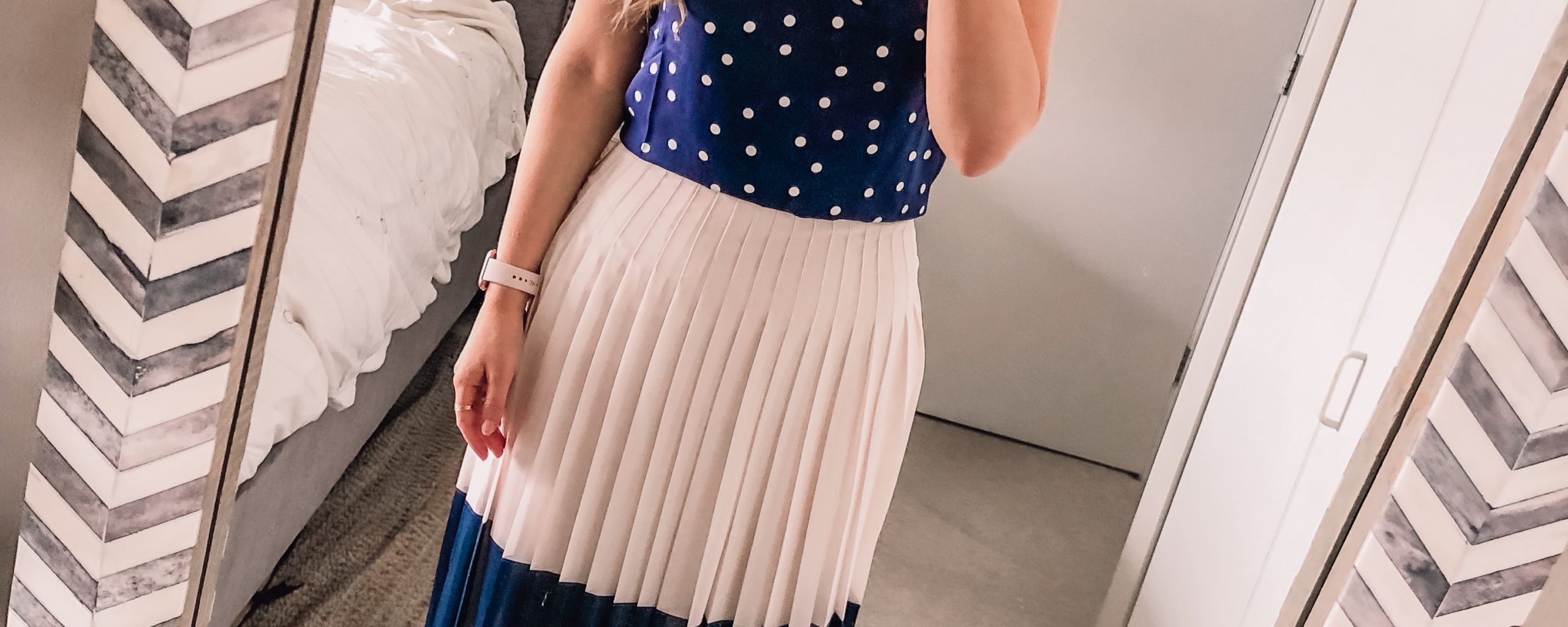 polka dot top and pleated navy skirt