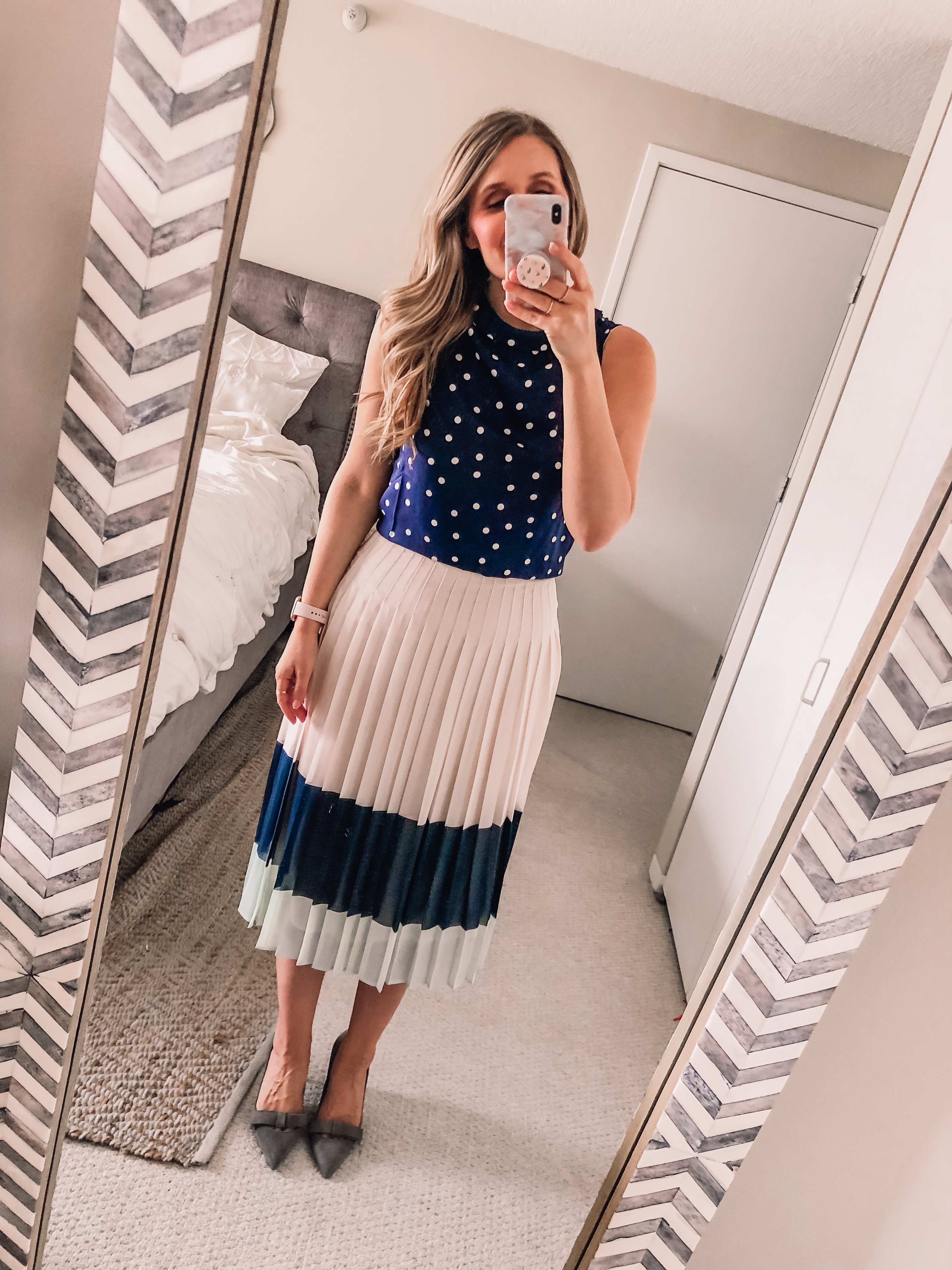 polka dot top and pleated navy skirt