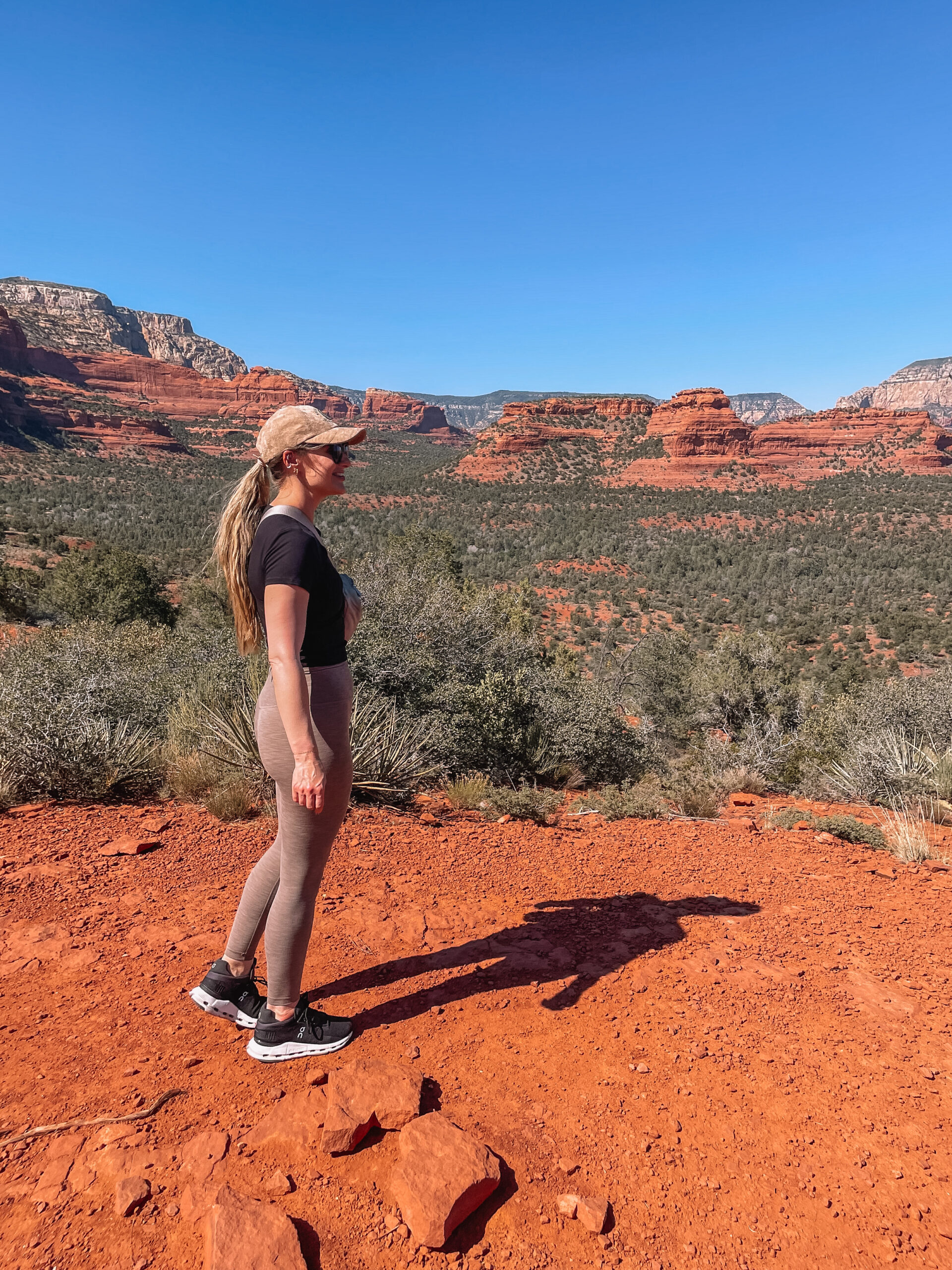 Group of women on a girls trip in Sedona, Arizona posing with red rock formations in the background during a scenic hike